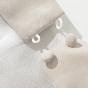 Close-up of beige fabric with a textured pattern on a light gray background