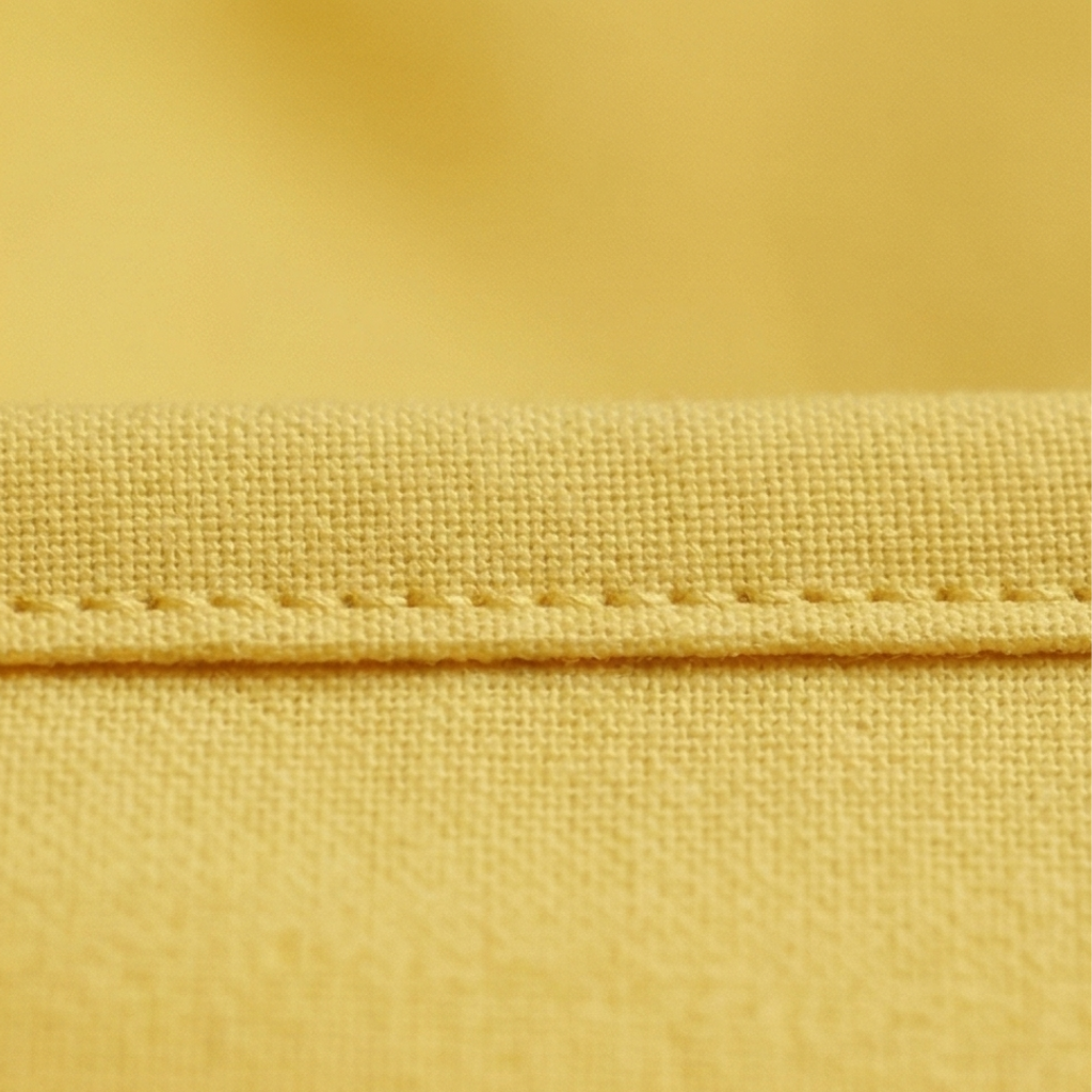 Close-up of yellow fabric with stitching detail