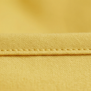 Close-up of yellow fabric with stitching detail