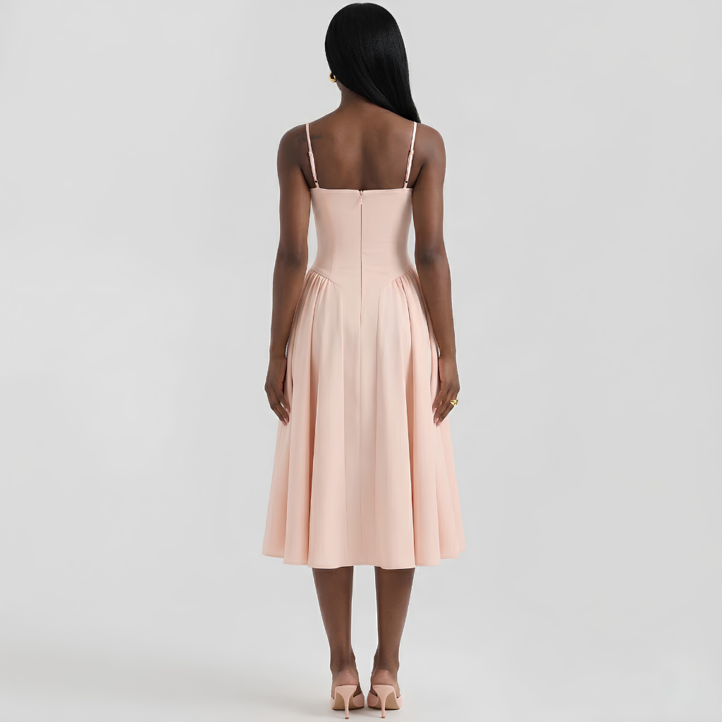 Woman wearing a light pink dress with thin straps on a white background